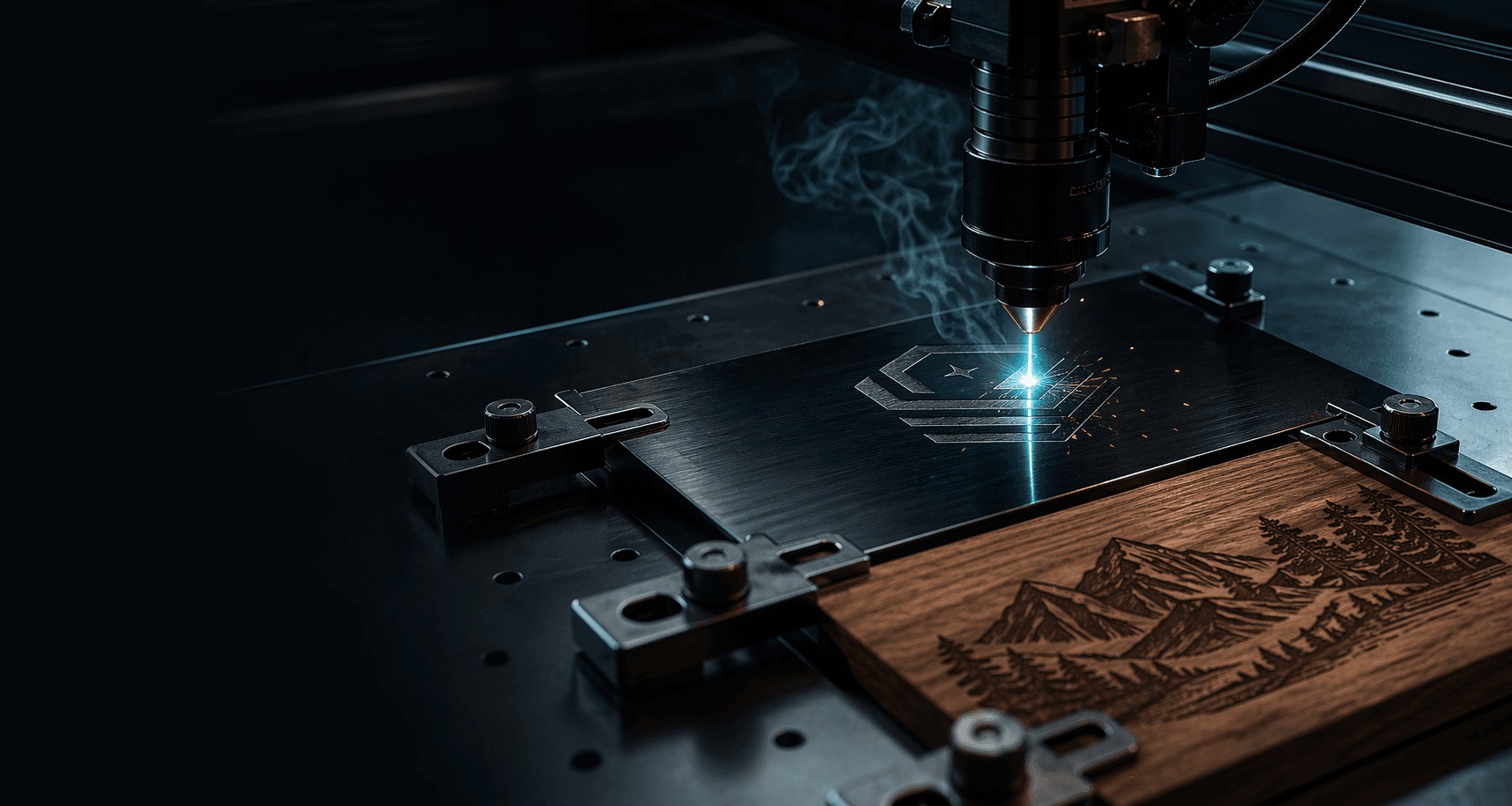 Laser engraver cutting a dark metal plaque beside an engraved wood sample.